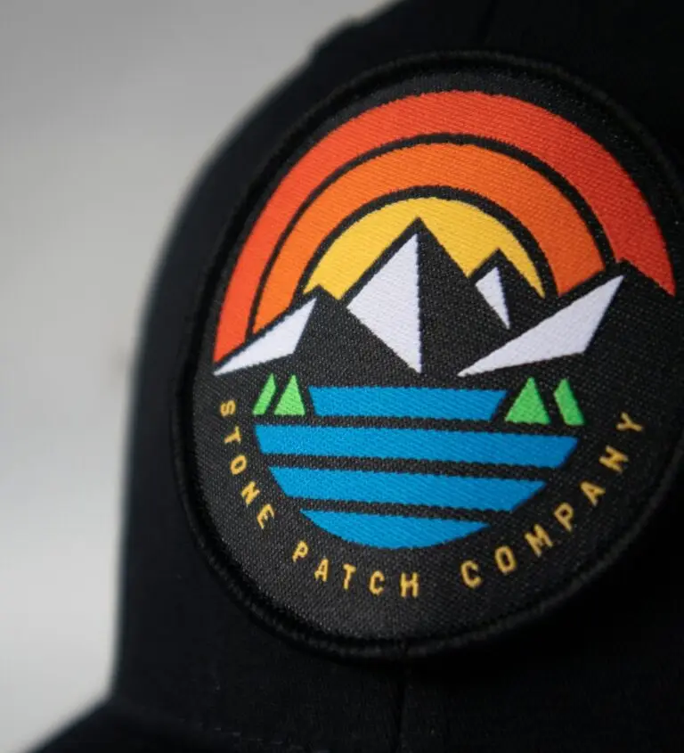 Embroidered mountain patch on a black cap made from vector artwork