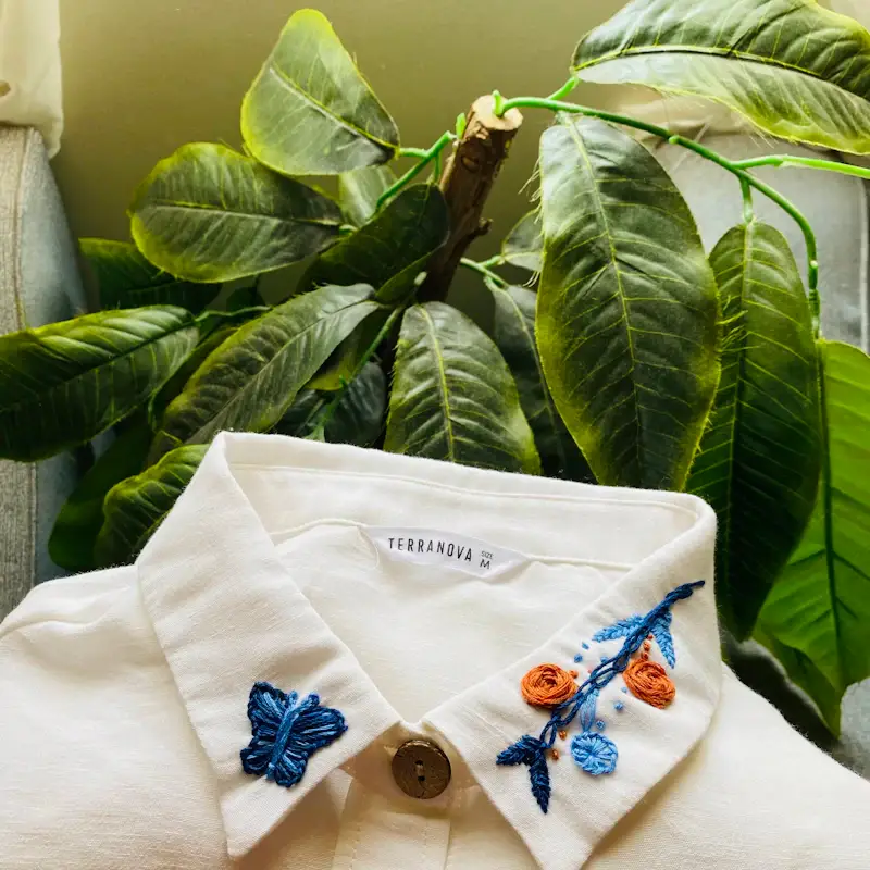 Embroidery artwork stitched on a white shirt collar