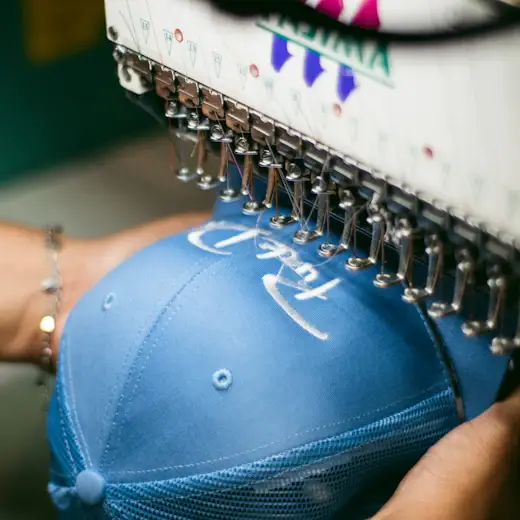 Cap logo being embroidered from clean embroidery vector artwork