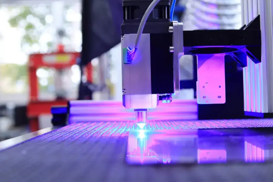 Laser engraving machine cutting a vector logo