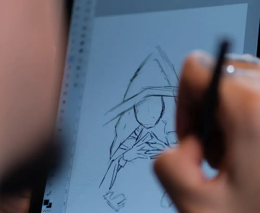 Designer manually tracing line art with a stylus for manual vectorization