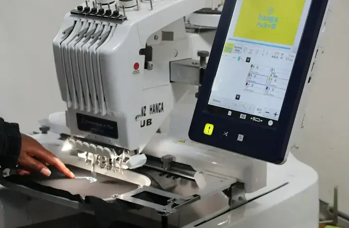 Embroidery machine stitching a logo after picture to vector conversion
