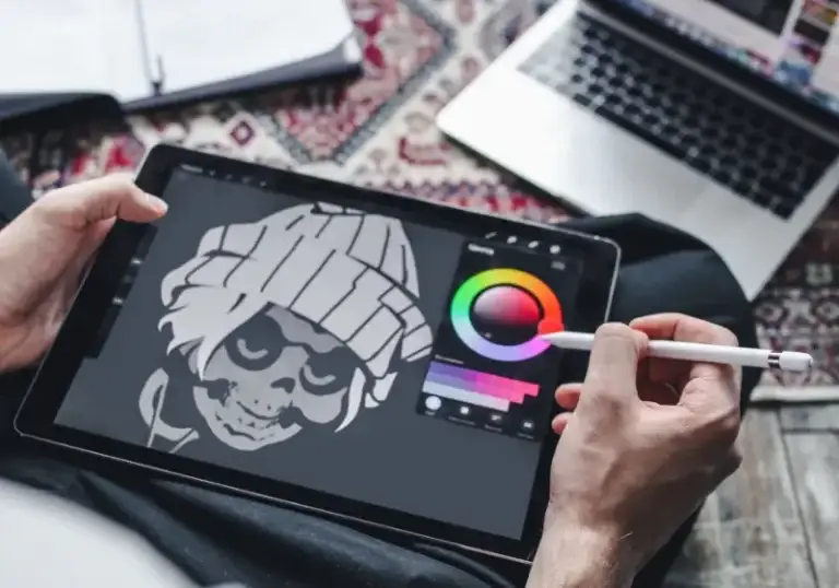 Designer redrawing a raster image as vector artwork on a tablet
