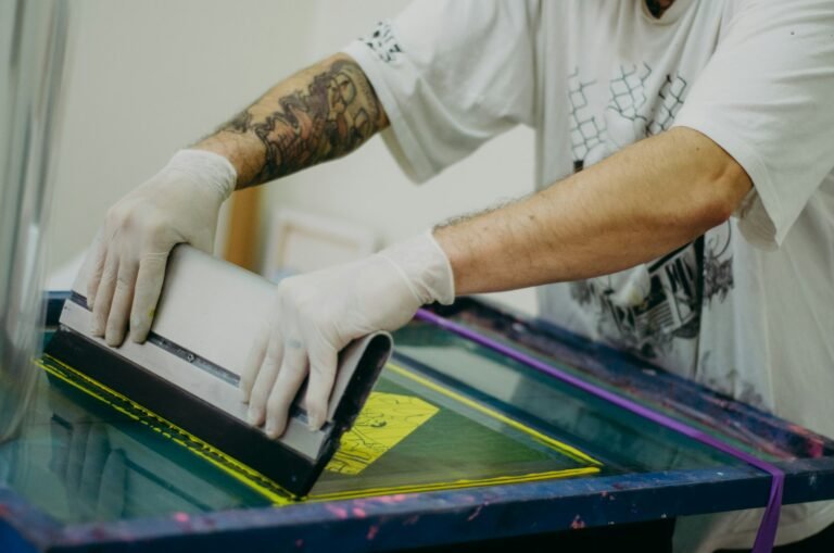 Screen printer pulling ink with color-separated vector artwork
